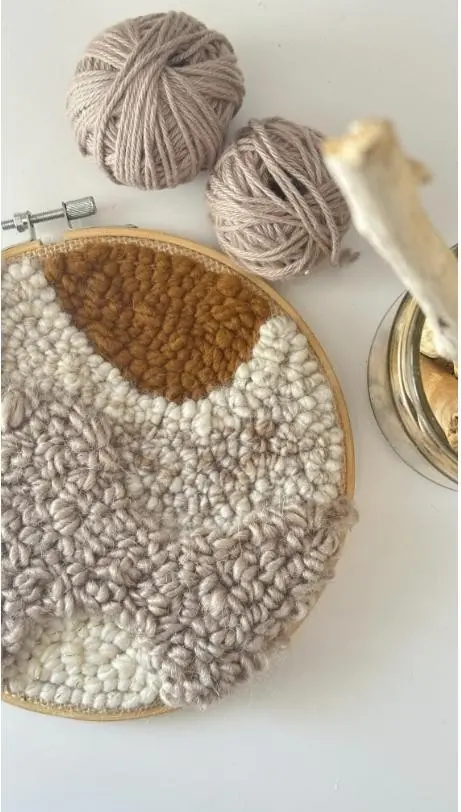 Punch needle hoop and yarn balls prepared for a private group workshop